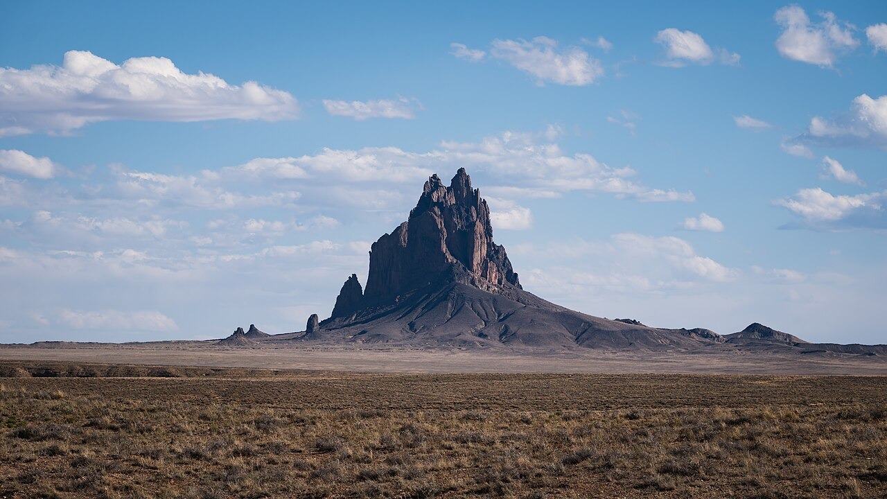 File photo: File photograph of Shiprock rising above the high desert plain in San Juan County, New Mexico; it does not depict the reported flooding. Illustrative context; not a photograph of the reported event.