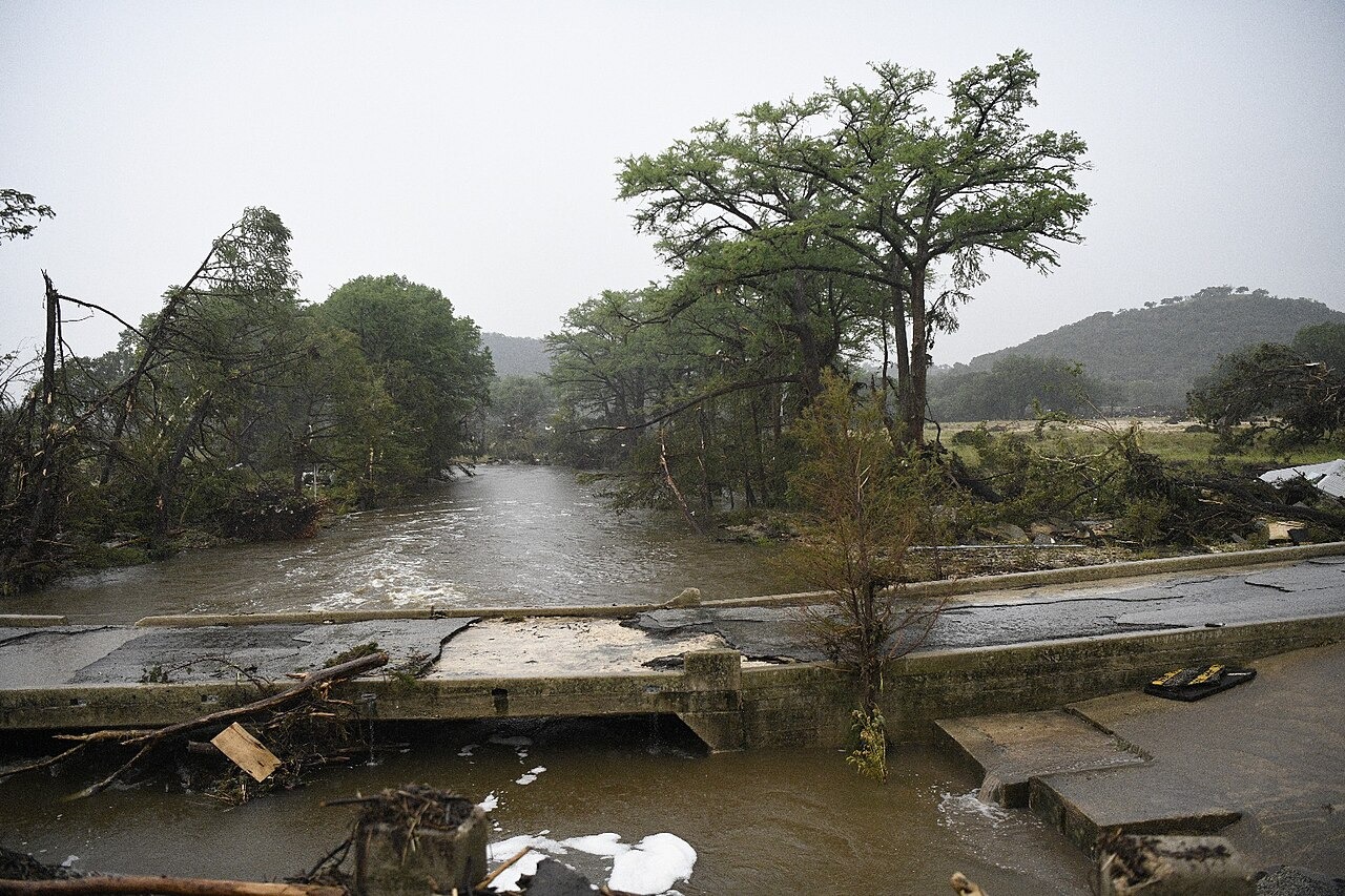 File photo: File photo showing floodwater and debris around a damaged roadway in Texas. Illustrative context; not a photograph of the reported event.